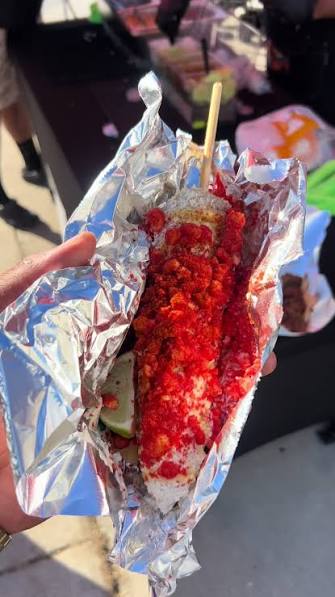 Hot Cheeto elote loaded in foil from Corn Lady LA